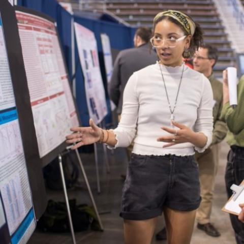 Graduate student presents her research poster